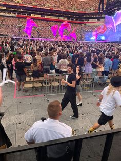 a crowd of people standing on top of a stage