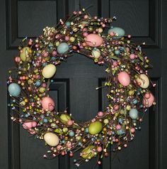 an easter wreath is hanging on the front door