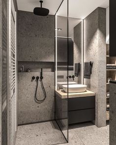 a bathroom with a shower, sink and mirror next to each other on the wall