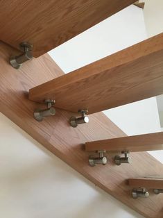 wooden railings with metal handles and knobs on the bottom part of them in a room