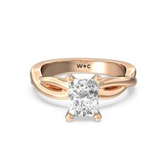 a rose gold engagement ring with a square cut diamond in the center and an intertwined band