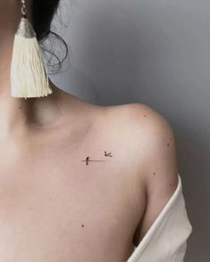 a woman with a small tattoo on her shoulder