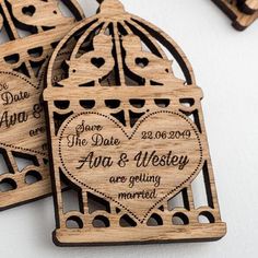 wooden save the date magnets with hearts in a birdcage design on them