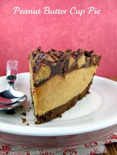 a piece of peanut butter cup pie on a white plate with a spoon next to it