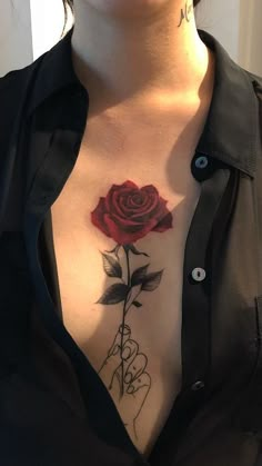 a woman with a rose tattoo on her chest