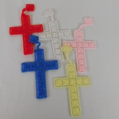 three different colored crosses on a white surface