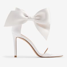 These Gorgeous Bridal Heels With A Classic Ankle Bow Detail Are The Perfect Statement Piece To Add To Your Look. Great For Your Wedding Or Other Special Occasions, These Will Have You Looking And Feeling Confident And Stylish. Features & Fabric Round Toe Sandals Strap Across The Toes Adjustable Ankle Closure; Bow Detail 4" Heel Padded Footbed Fabric/Metal Imported White Heels With Bow For Events, White Heels With Bow And Open Heel, White Open Heel Heels With Bow, White Ankle Strap Heels For Events, Elegant White Heels With Bow, White Pointed Toe Sandals For Event, White Pointed Toe Sandals For Events, White Closed Toe Heels For Events, White Pointed Toe Heels With Bow