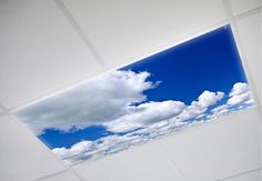 the sky is blue and white with some clouds in it as seen from inside an empty room