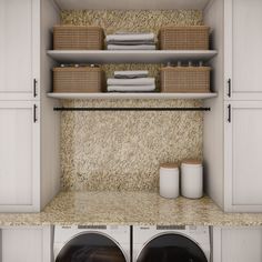 a washer and dryer in a room next to each other with baskets on the shelves