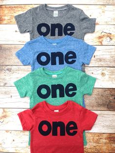 three children's t - shirts with the words one, one, and one on them