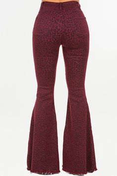 the back view of a woman wearing red leopard print flared flare pants with high waist and bell bottoms