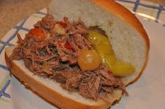 a close up of a sandwich on a plate with words above it that reads italian beef in a bucket