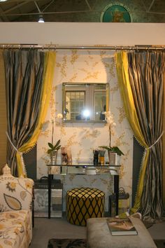 a living room filled with furniture and curtains