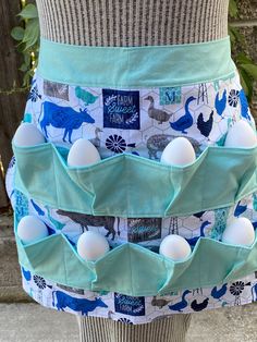 a woman's skirt with eggs in the back and an image of dinosaurs on it