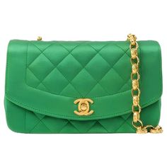 Chanel Diana Flap Bag 1990 Mini Green Silk Satin Bijou Chain These are professional photos of the actual bag offered by Luxbags. This exquisite Chanel Diana Flap Bag from 1990 is more than just a bag - it is a luxurious piece of jewelry, a bold fashion statement, and a priceless treasure. Made from emerald green silk satin and adorned with 24k gold plated hardware, it exudes opulence. The bijou gold-tone chain adds an extra touch of glamour to this already stunning masterpiece. CONDITION: VERY GOOD Slight rubbing around the corners, and flap. With slight fading on eyelet, slight rubbing behind of flap, slight scratch on turn-lock. DETAILS: Year: 1990 Made in France TIMELESS PIECES. Chanel Diana Size mini Height 11cm x Width 18cm x Depth 5cm Shoulder drop: 108cm. Green Silk satin ACCESSORY: Green Chanel Bag, Green Chanel, Green Interior, Silk Bag, Chain Bag, Green Silk, Fendi Bags, Chain Bags, Flap Bag