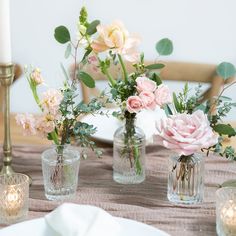 the table is set with flowers and candles