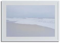 an ocean scene with waves coming in from the water and white sand on the beach