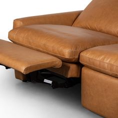 a brown leather reclining chair and footstool sitting next to each other on a white background