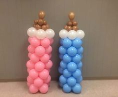 two tall balloons with teddy bears on them are sitting next to each other in front of a wall