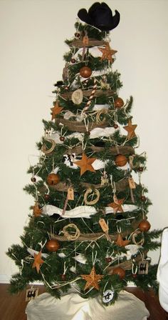 a decorated christmas tree with cowboy hats on top