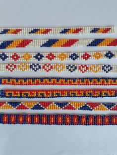 four beaded bracelets with different colors and designs