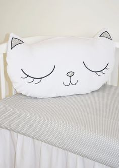 a white pillow with a cat face on it