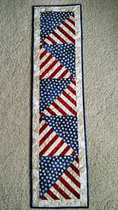 an american flag tie is hanging on the wall in front of a carpeted floor