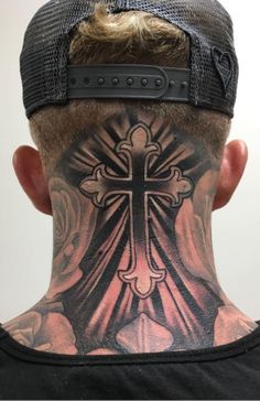 the back of a man's head with a cross tattoo on his upper part