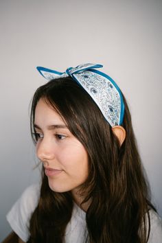 Add this feminine headband for the perfect finishing touch to your outfit! The scarf style bow knot detail is so fun and boho!  -Eye-catching satin fabrics -Bow knot detail -Comfortable, no-hurt headband -Soft, satin scarf-like fabric-covered for comfort wear -About 5.5 inch wide -One size fits all Summer Knotted Headscarf, Spring Satin Bow Hair Accessories, Spring Hair Accessories With Satin Bow, Casual Blue Headband For Spring, Spring Bandana Print Headscarf, Summer Adjustable Ribbon Headband, Blue Bohemian Bandana For Summer, Bohemian Bandana With Matching Headband For Spring, Adjustable Blue Bohemian Headscarf