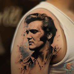 a man's arm with a portrait of elvis presley in the middle and stars on it