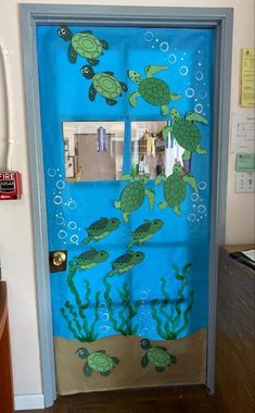 a door decorated to look like a sea turtle with bubbles and fish in the water