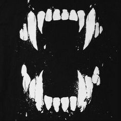 a black and white photo of a scary face with teeth on it's side