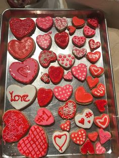 a tray filled with lots of heart shaped cookies