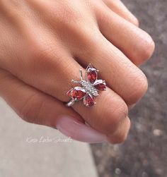 Garnet CZ butterfly silver ring, clear - Red - butterfly ring, silver ring, promise ring - 925 sterling silver Height: 16.0mm Width: 17.0mm Shank Width: 1.7mm Stone Material: Garnet CZ and White Cubic Zirconia Center Stone Size: 7.0mm x 5.0mm & 6.0mm x 4.0mm Stone Shape: Pear and Round Center Stone Carat Weight: 0.71 ct. & 0.39 ct. Number of CZ Stones: 8 Stone Setting: Prong Metal: 925 Sterling Silver Plating: Rhodium Finish: High Polish simply stunning. High Polished, solid 925 sterling silver. Rhodium plated to prevent tarnishing. TARNISH FREE Rhodium plated to avoid tarnishing Nothing but the best from my custom jewelry store. Email me if you have any questions. Fine Jewelry Cubic Zirconia Butterfly Ring For Anniversary, Formal Butterfly-shaped Cubic Zirconia Rings, Elegant Cubic Zirconia Butterfly Ring Gift, Elegant Butterfly Ring With Cubic Zirconia For Gift, Elegant Butterfly Ring Cubic Zirconia Gift, Butterfly-shaped Cubic Zirconia Wedding Rings, Butterfly Cubic Zirconia Wedding Rings, Butterfly-shaped White Gold Jewelry For Wedding, White Gold Butterfly Jewelry For Wedding