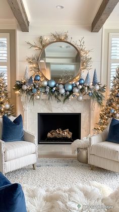 a living room decorated for christmas with blue and silver decorations