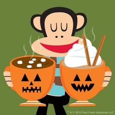 a monkey holding two pumpkin mugs with whipped cream in them