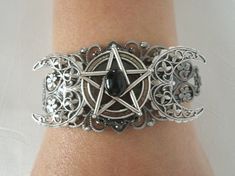 This beautiful silver plated filigree cuff bracelet has a silver plated triple moon design and a pewter silver pentacle with an obsidian setting. Adjustable. Wiccan Jewelry Goth, Pagan Jewelry Gryphon's Moon, Adjustable Moon-shaped Spiritual Jewelry, Pagan Jewelry Moon Goddess, Nickel-free Moon Shaped Spiritual Jewelry, Moon Pentacle, Wicca Jewelry, Gothic Bracelet, Wiccan Jewelry