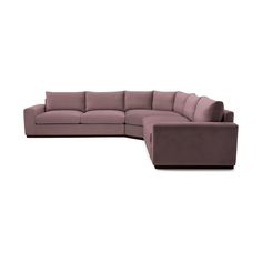 a large sectional couch with pillows on the top and bottom corner, in purple fabric