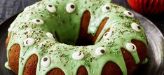 a bundt cake with green icing and eyes on it