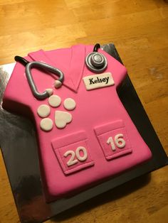 a cake shaped like a doctor's coat and stethoscope