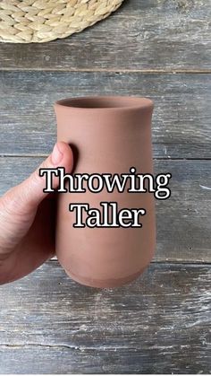 a hand holding a brown vase with the words throwing taller on it