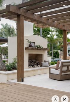 an outdoor living area with fireplace and seating