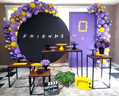 purple and yellow balloons decorate the entrance to a party