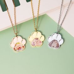 Always close to your heart These Pet Footprint Photo Necklaces are a perfect way to keep your little loved ones near and dear to you wherever you go. These necklaces make the perfect gift for any pet lover, a memorial gift or even for yourself! Customize with your favorite photo Material Pendant Material: Stainless Steel Product Finish: Silver, Gold, and Rose Gold Necklace chain length: 20" Necklace weight: 8g How to order your personalized necklace Upload a clear, well lit, and high-quality pic Round Pendant Necklace With Paw Print For Gift, Paw Print Necklaces For Valentine's Day Gift, Valentine's Day Gift Necklaces With Paw Print, Relationship Jewelry, Lucky Charm Necklace, Frame Purse, Daughter Jewelry, Sparkle Necklace, Diamond Necklace Set