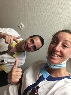 two people with braces and ties on giving the thumbs up sign while one person is wearing an oxygen tube