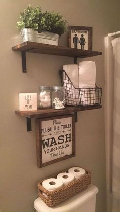 a bathroom with two shelves above the toilet