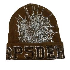 Stay warm and stylish with our Sp5der Beanie, available in all colors. The Sp5der logo is prominently displayed, showcasing your love for the brand. Crafted with quality materials, this beanie is a must-have for any fashion-forward individual. Keep cozy while representing your favorite brand. Fabric: 100% cotton One size fit all. Trendy Winter Beanie With Letter Print, Trendy Letter Print Beanie For Winter, Trendy Brown Beanie For Fall, Trendy Fall Beanie Cap, One Size Beanie For Fall Streetwear, One Size Beanie For Streetwear In Fall, Trendy One Size Beanie For Fall, Streetwear Accessories, Streetwear Women