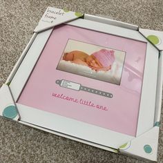 a baby photo frame with a welcome little one on it