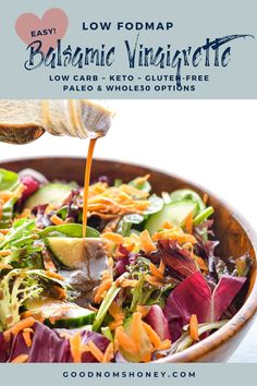 a wooden bowl filled with salad and dressing being drizzled over the salad