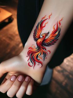 a woman's arm with a red and yellow tattoo design on the left wrist